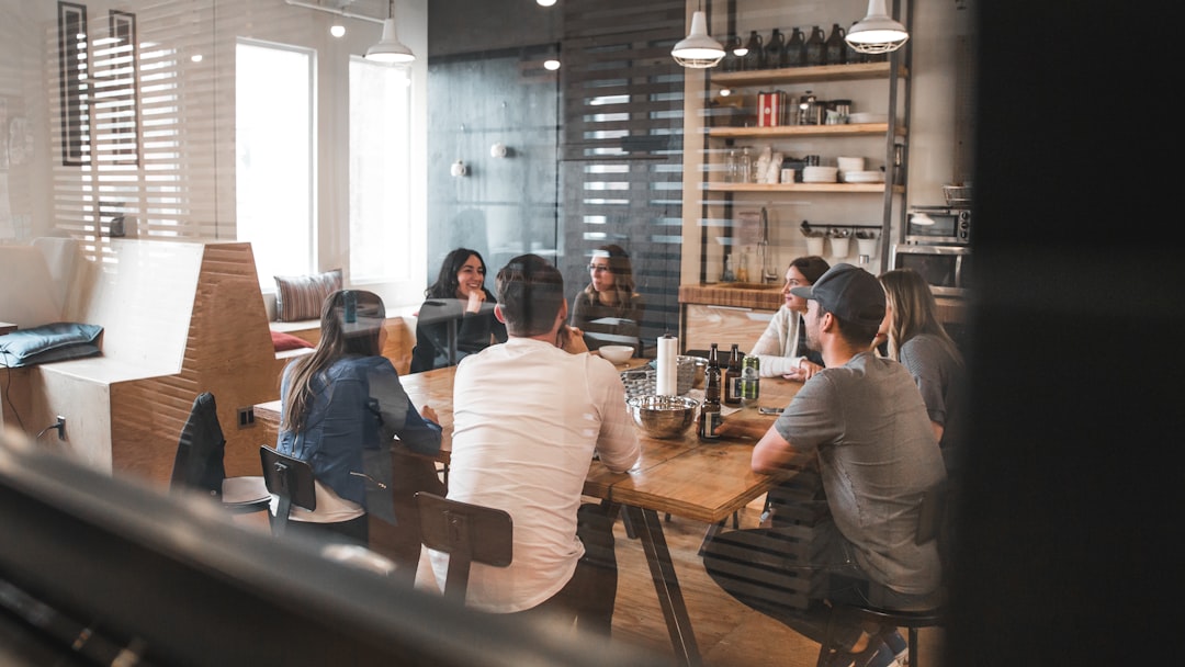ThierIT concept — leadership in conversation A leadership team discussing decisions around a table